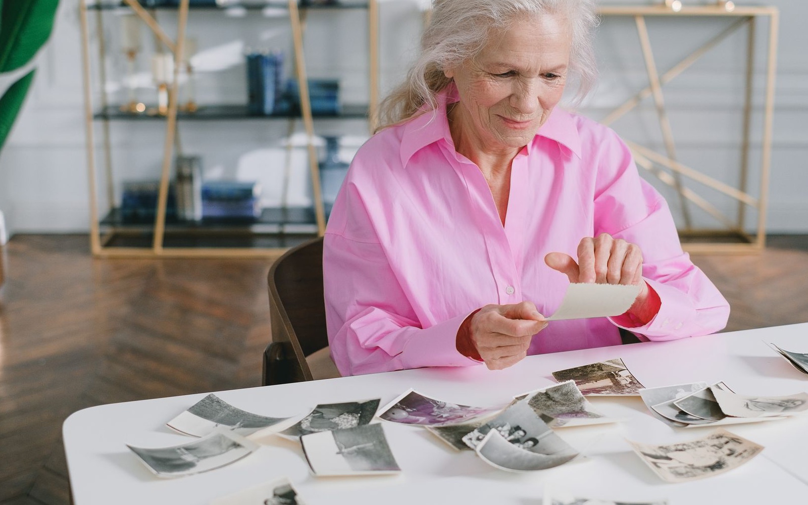 A senior woman looking through her family photograph collection